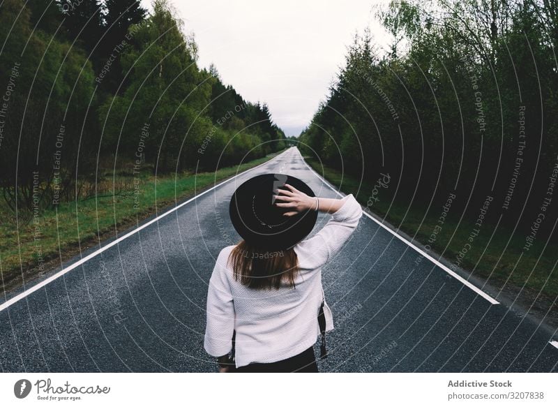 Stylish woman on remote empty road nature travel style landscape green scotland solitude alone lush hat beautiful summer beauty country way journey trip posture