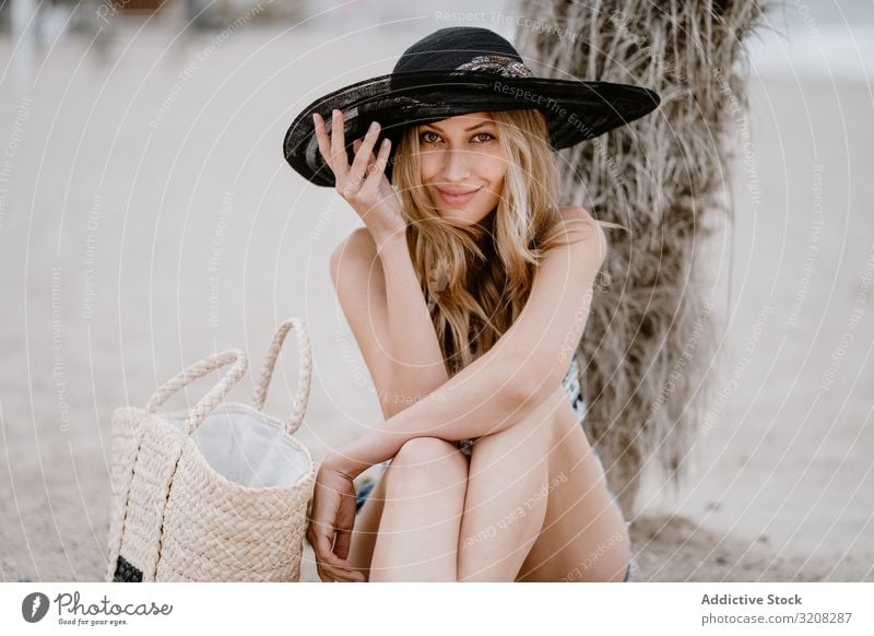 Young beautiful female relaxing on beach woman hat fashionable glamorous summer vacation travel recreation holiday resort young person attractive blonde pretty