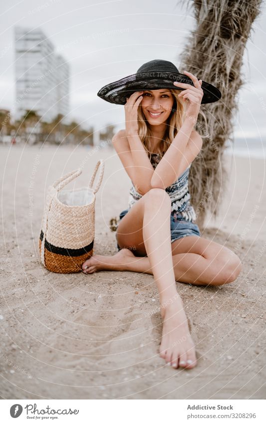 Young beautiful female relaxing on beach woman hat fashionable glamorous summer vacation travel recreation holiday resort young person attractive blonde pretty