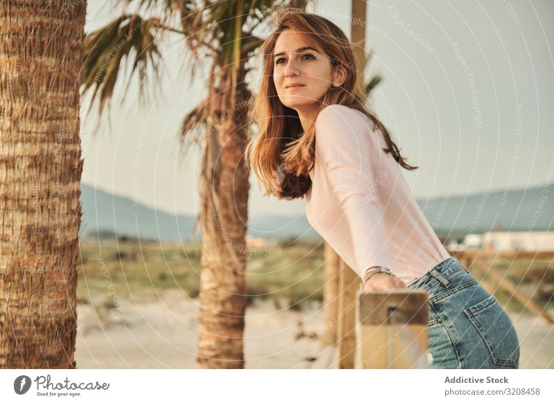 Woman on beach enjoying sunset woman travel railing idyllic inspiration peace harmony vacation contemplate palm beautiful cadiz tarifa spain wall lean elegant