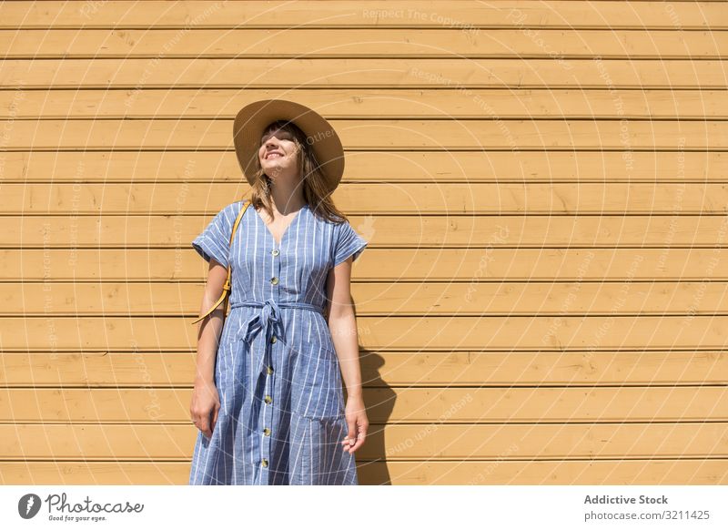 Young woman enjoying sunshine in summertime freedom smiling straw hat pretty weekend tourism carefree content delighted young adult vacation happiness beautiful