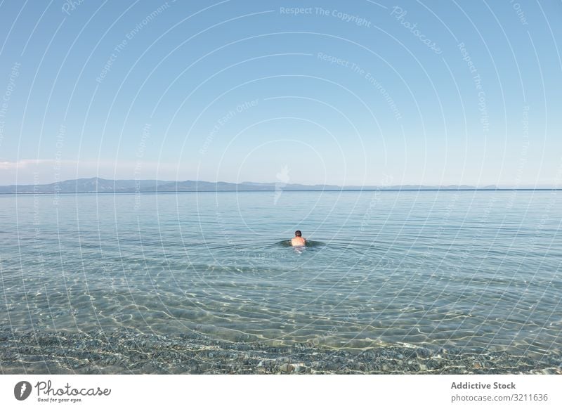 Man swimming in clear water in sunlight man sea ocean vacation summer travel greece halkidiki adventure lifestyle calm activity trip tranquil serene athlete