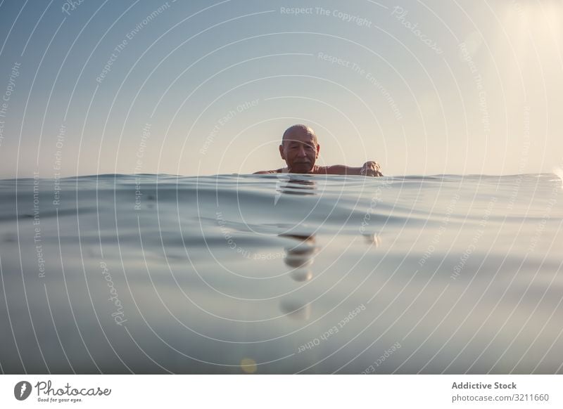 Man swimming under water in sea man underwater elderly vacation retired greece halkidiki covered leisure submerge chill old ocean marine nautical summer travel