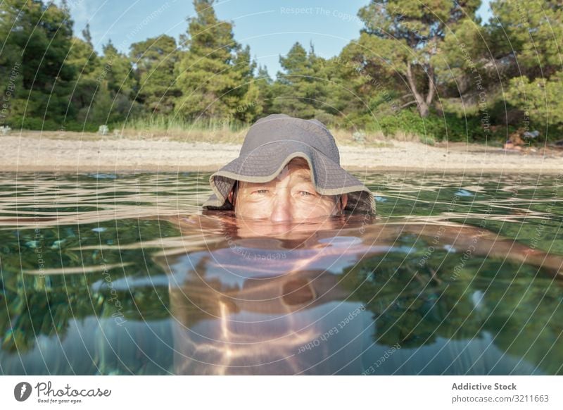 Man swimming under water in sea man underwater elderly vacation retired greece halkidiki covered leisure submerge chill old ocean marine nautical summer travel