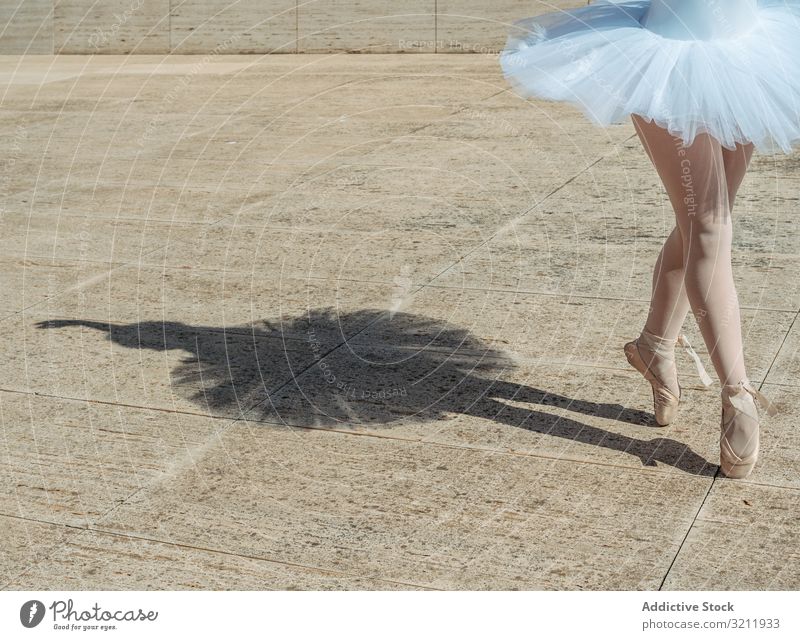 Ballerina standing on tiptoe classical position outside ballerina shadow dance elegance dancer flexibility ballet posing exercise beautiful woman balance female