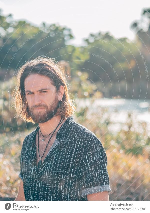 Hipster man near river hipster nature swim summer unbuttoned shirt relax smile environment cheerful happy beard holiday trip vacation adventure tropical