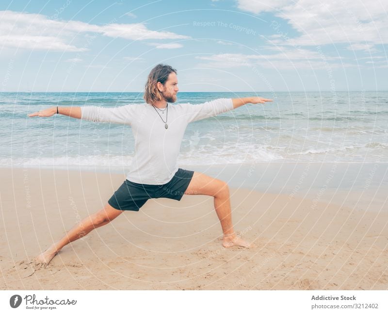 Man training yoga on beach man rest harmony asana exercise seashore energy meditation equilibrium stretch zen relax balance sport lifestyle calm male bearded