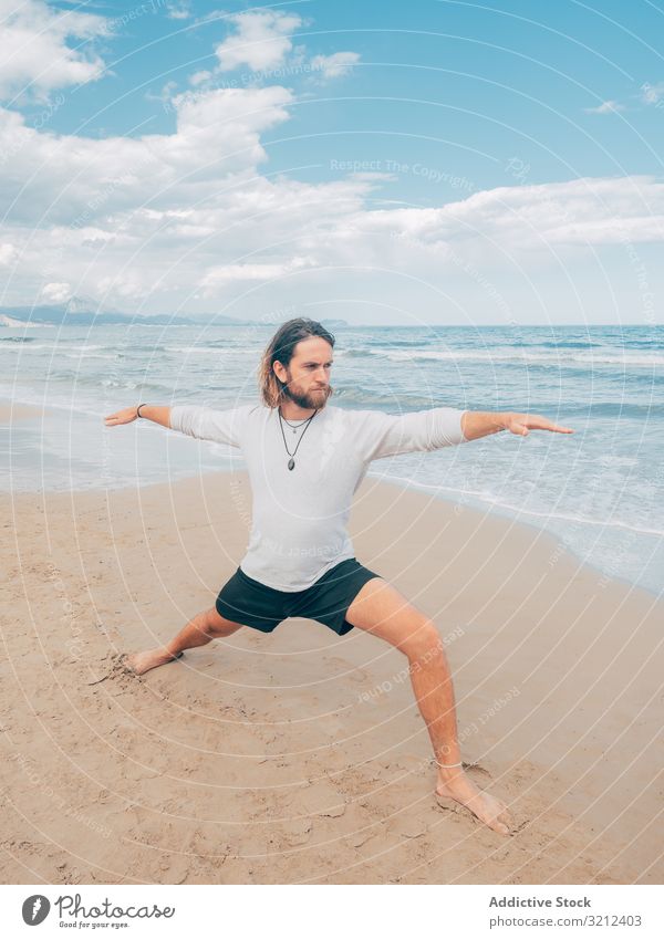 Man training yoga on beach man rest harmony asana exercise seashore energy meditation equilibrium stretch zen relax balance sport lifestyle calm male bearded