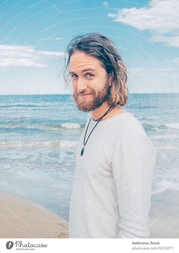 Man standing on the beach man rest calm relaxed resort harmony summer beard hobby vacation active ocean resting male travel happy handsome attractive adult