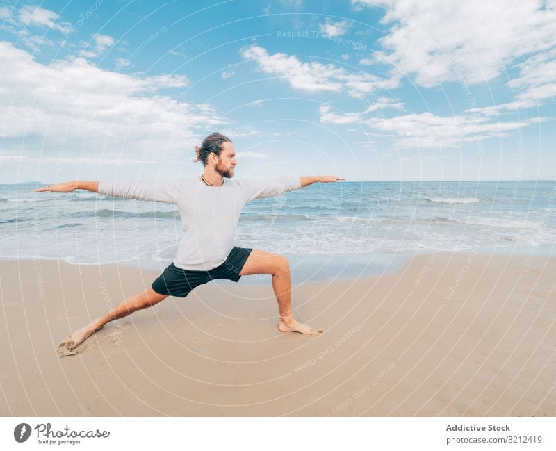 Man training yoga on beach man rest harmony asana exercise seashore energy meditation equilibrium stretch zen relax balance sport lifestyle calm male bearded