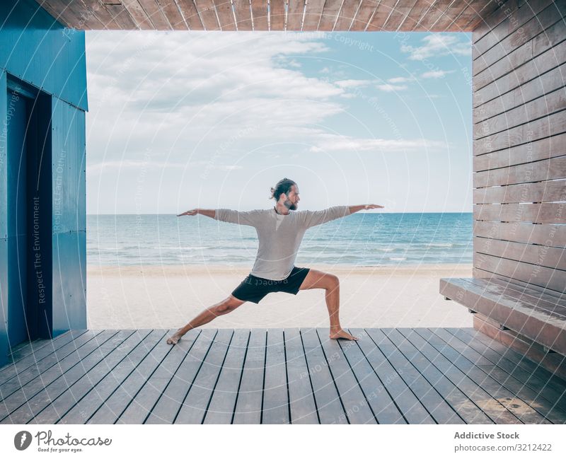 Man doing yoga by the beach man rest calm resort brutal harmony relax summer beard practice hobby asana sport vacation stretching active sitting training ocean