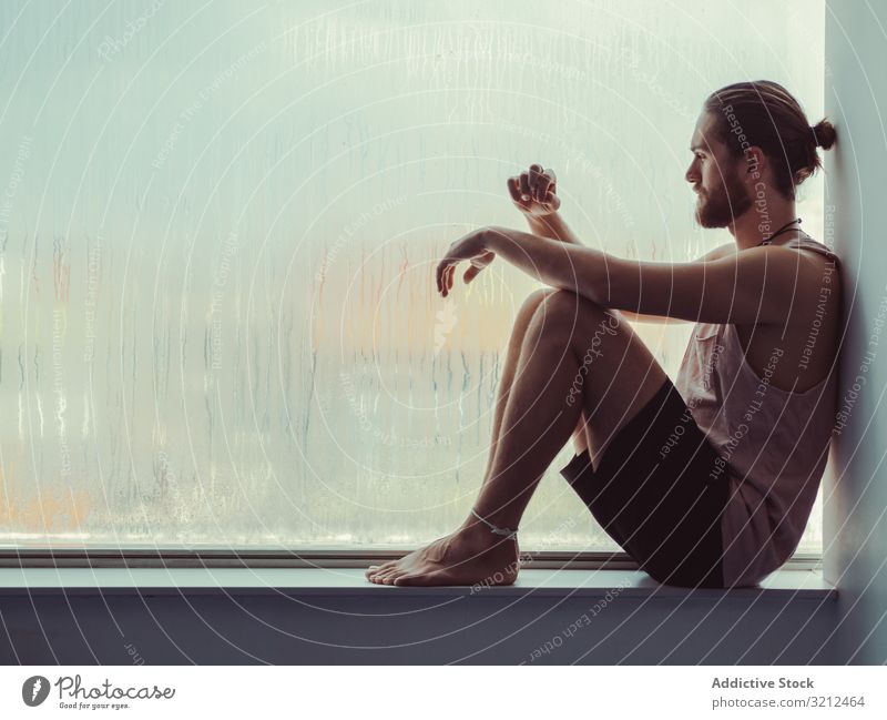 Man in mindfulness on window sill man relax tranquil peace training fitness meditation body lifestyle spiritual health sport windowsill balance sportsman young