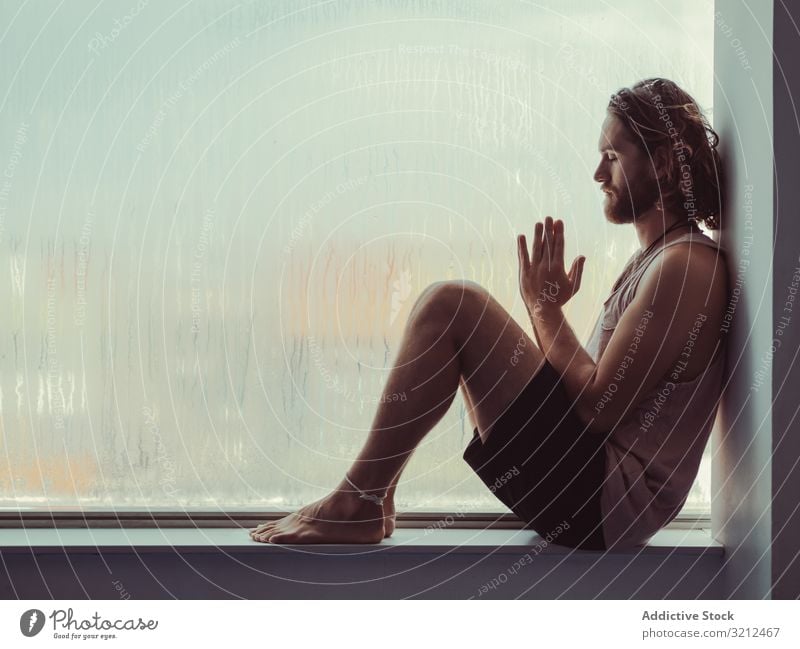 Man in mindfulness on window sill man relax tranquil peace training fitness meditation body lifestyle spiritual health sport windowsill balance sportsman young