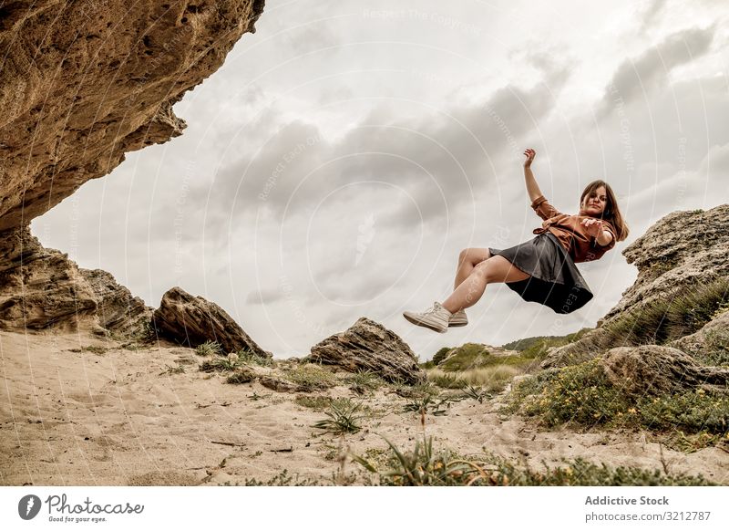 Beautiful girl levitating above mountains freedom fantasy air fearless fly zero gravity elegance female landscape magical relax calmness beautiful reach cloudy