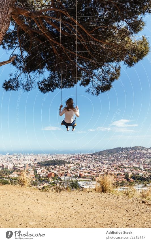 Young girl swinging over the city happy background young female people summer concept person leisure cityscape fashion little childhood outdoor happiness joy