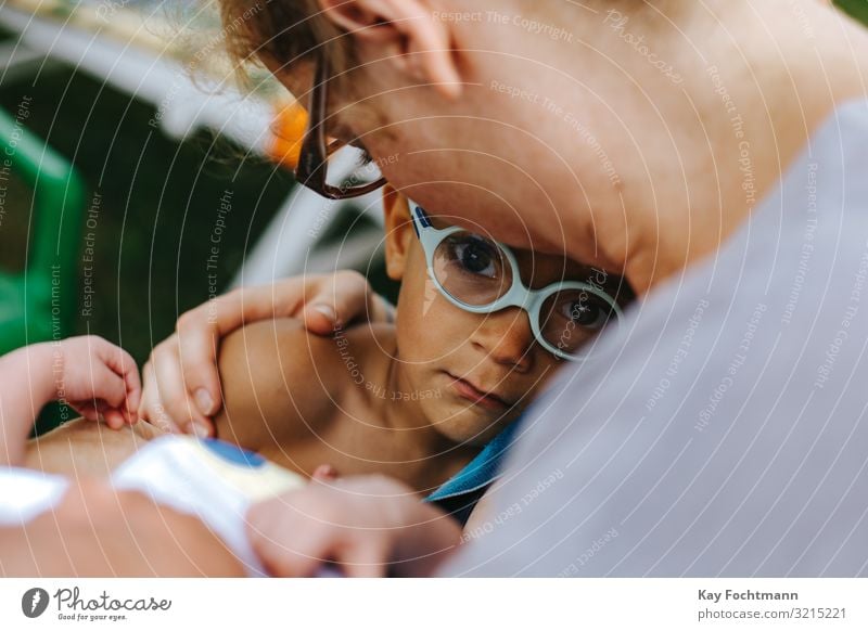 little colored boy taking comfort in his mother's arms affection afraid beautiful bonding care caring caucasian child childhood concerned cute holding infant