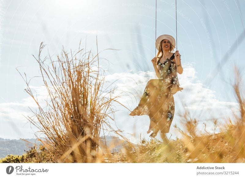 Happy girl enjoying on a swing at sunset happy woman happiness nature beautiful silhouette young lifestyle vacation landscape summer people dress freedom