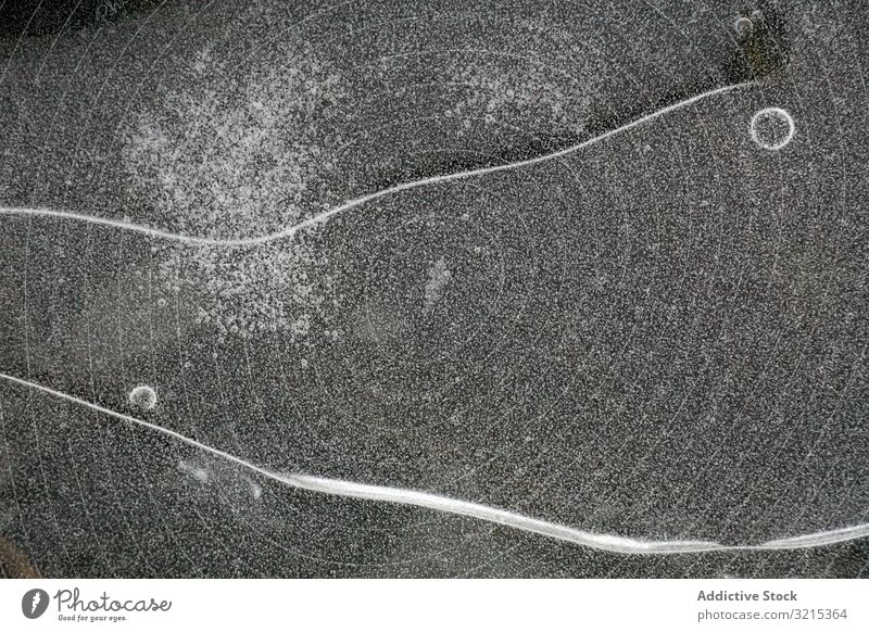 Fragment of thin ice on dark frozen river water fragment ice coating cold surface nature pattern texture season wilderness winter frost lake pond bubble