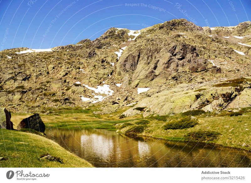 Picturesque view of lake in mountain area lawn travel picturesque beautiful calm stony sunny day water landscape summer nature scenic countryside rocky trip