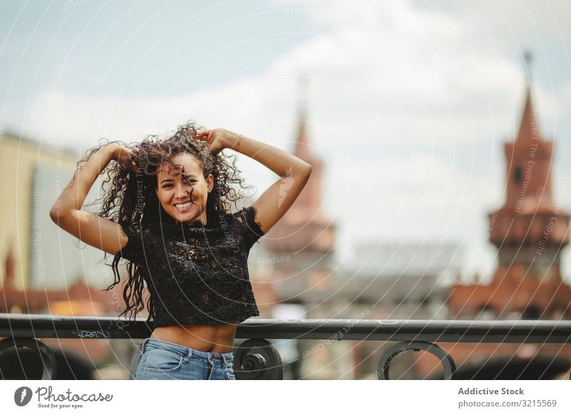 Beautiful ethnic woman leaning on railing model beautiful berlin young fashion stylish trendy female gorgeous elegant urban charming feminine sightseeing city