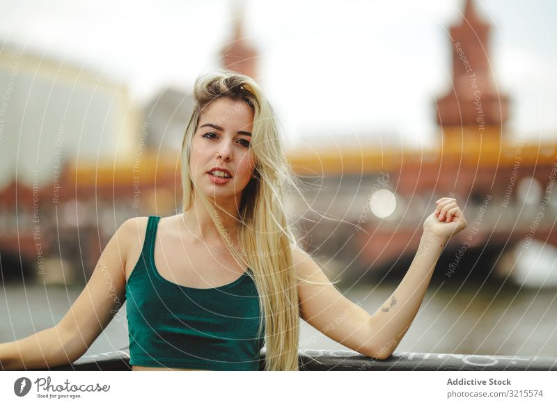 Beautiful blonde woman leaning on railing model beautiful berlin young fashion stylish trendy female gorgeous elegant urban charming feminine sightseeing city