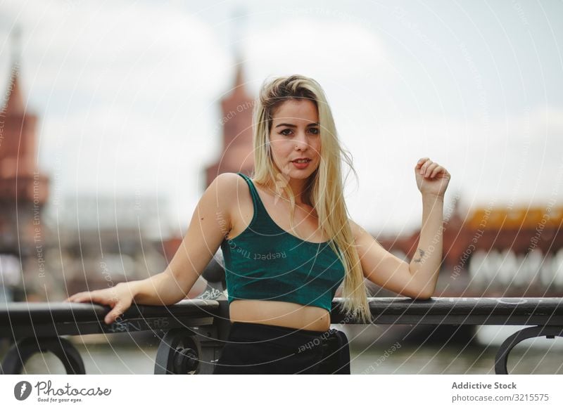 Beautiful blonde woman leaning on railing model beautiful berlin young fashion stylish trendy female gorgeous elegant urban charming feminine sightseeing city