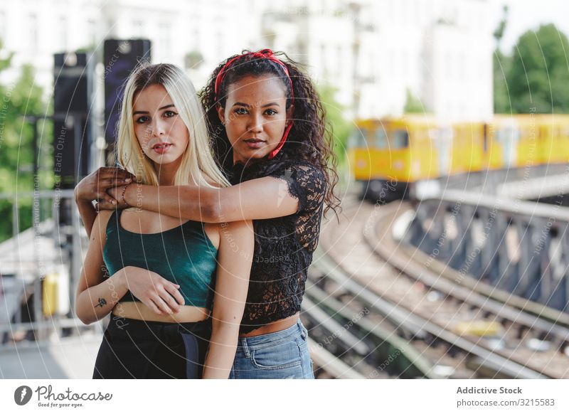 Friends standing on train platform woman friend beautiful berlin sunny young together summer trendy bonding casual stylish pretty multiracial multiethnic urban