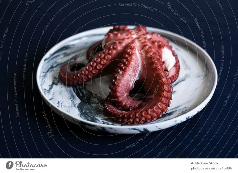 Red fresh fleshy octopus in white plate seafood tasty delicatessen appetizing dinner luxury ingredient natural omega freshness delicacy frozen eating oceanic