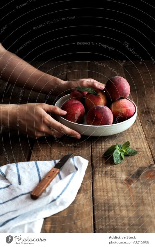 Tasty ripe peaches in plate hands vegetarian food organic fruits raw fresh natural harvest delicious leaf unpeeled plant cut knife juicy refreshment freshness