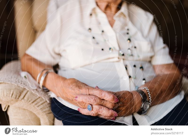 Portrait of aged female in white shirt at home woman grandmother experience wisdom attention grandparent generation senior elderly wrinkle granny gray haired