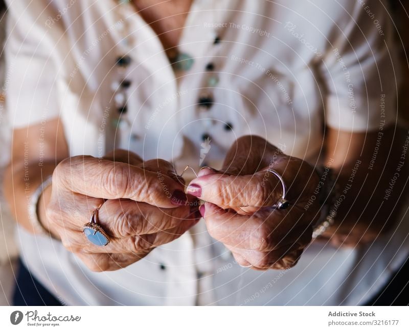 Aged woman with threads sitting at home aged knitting experience wisdom grandmother hobby handmade attention grandparent generation senior elderly female