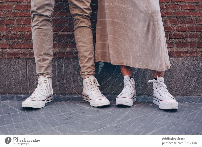 Crop view of couple feet in street people city anonymous pedestrian busy lifestyle travel sidewalk urban outdoor pavement road walking legs modern foot friends