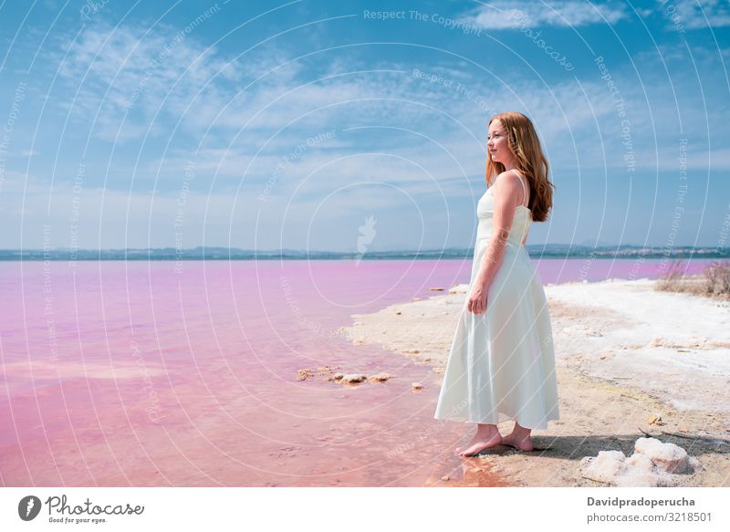 Side view of cute teenager woman wearing summer clothes on pink lake young saline romantic white tourism happy alone sea colorful nature water copy space salty