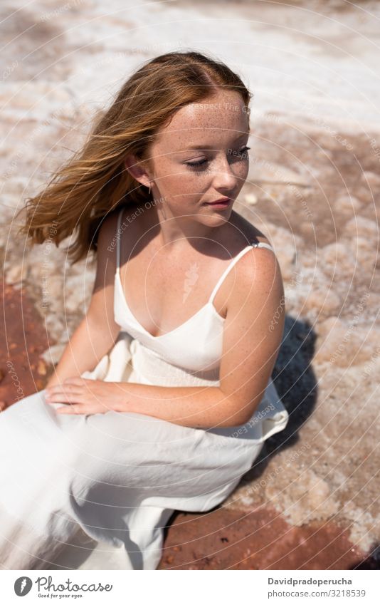 cute teenager woman wearing white dress sitting on an amazing pink lake young saline romantic tourism summer freckles happy alone sea colorful water copy space