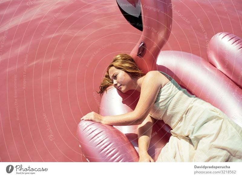 Beautiful woman lying on inflatable float mattress on pink sea female beach relax nature beautiful sunny cute young paradise salt halobacteria Spain water