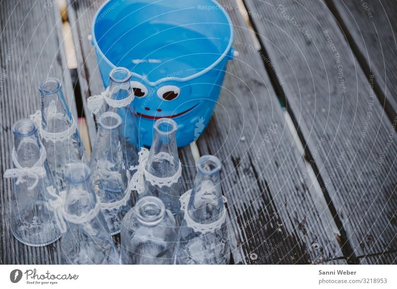 Blue bucket with face Plastic Happy Glass Bottle loop belt White Bucket Face Wood Floor covering Wet Colour photo Multicoloured Exterior shot Close-up