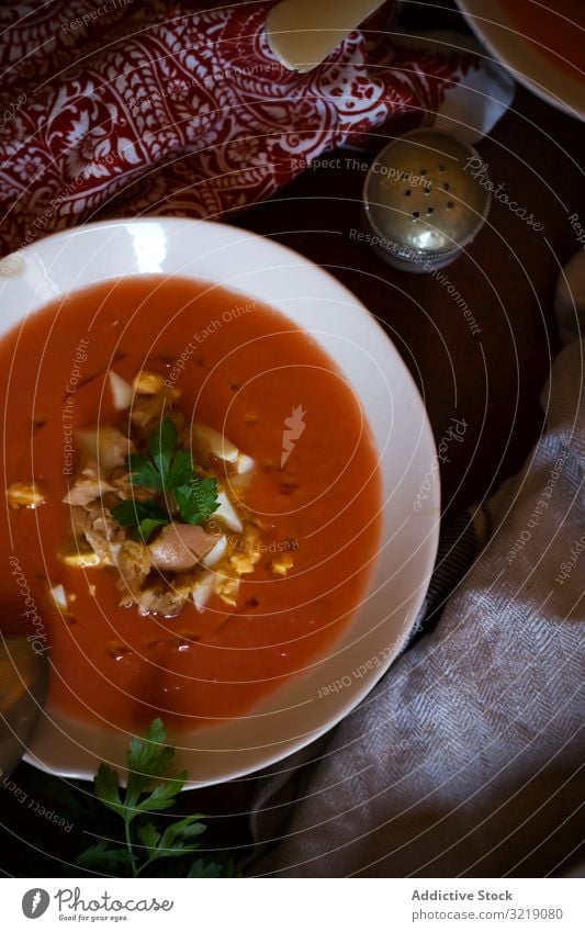 Bowls of fresh tomato soup gazpacho bowl parsley table napkin food meal cuisine healthy vegan dinner lunch vegetable vegetarian delicious tasty yummy delectable