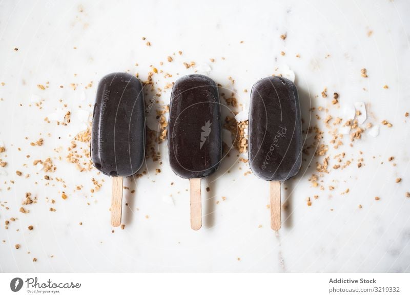 Three chocolate popsicles Chocolate Ice Cream Vanilla Almond ice cream background summer dessert delicious stick food brown sweet cold tasty flavor dairy creamy