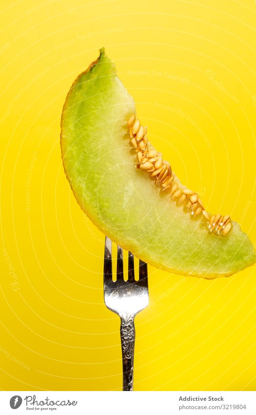 Piece of melon strung on shiny fork slice tasty fruit delicious minimalism summer natural healthy fresh juicy organic diet eat vitamin dessert ripe sweet cut