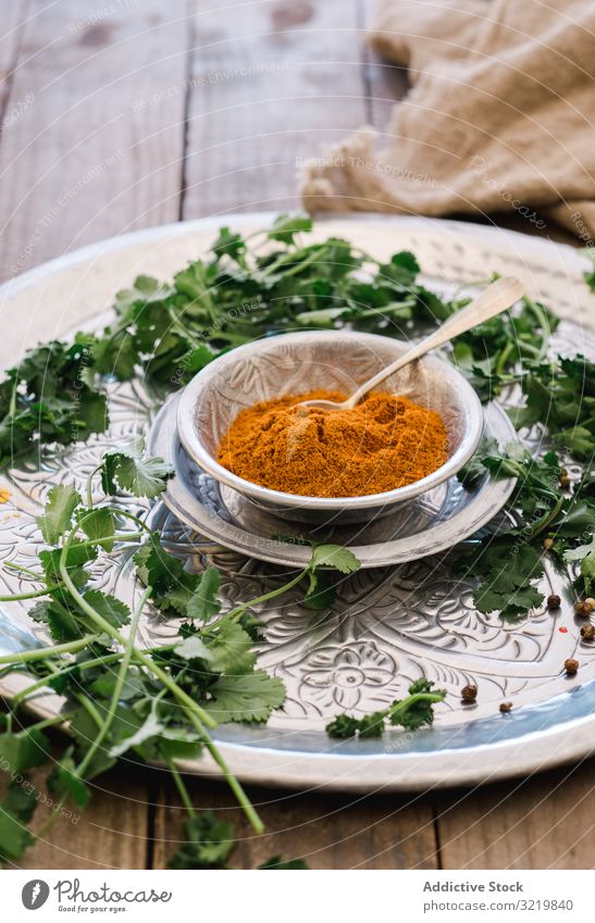 Turmeric in silver bowl with herbs on table turmeric spice food green fresh organic spicy diet herbal ingredient condiment dish cuisine asian recipe powder