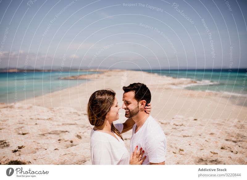 Loving couple embracing on coastline Formentera balearic islands Spain embrace seashore beach ocean romantic seaside nature relationship summer weekend