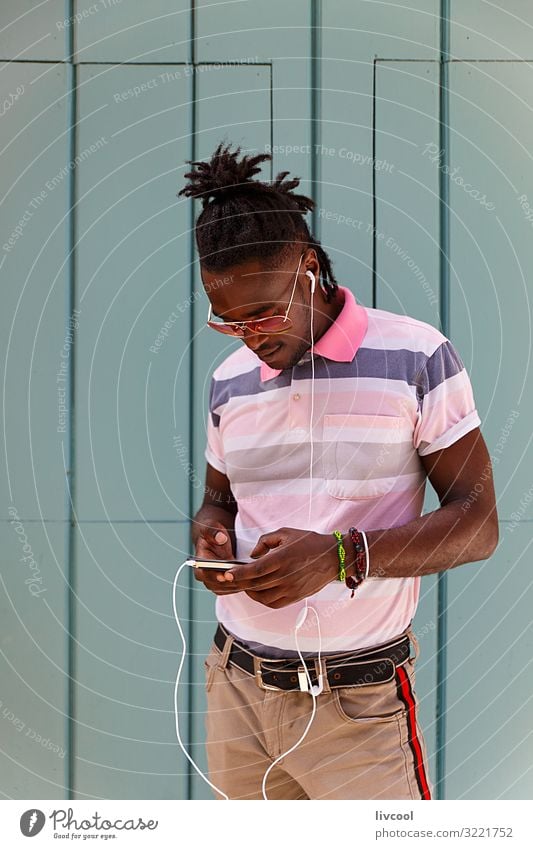 young cuban with afro hair using his cell phone, havana - cuba Lifestyle Happy Island Human being Masculine Young man Youth (Young adults) Man Adults Body Head