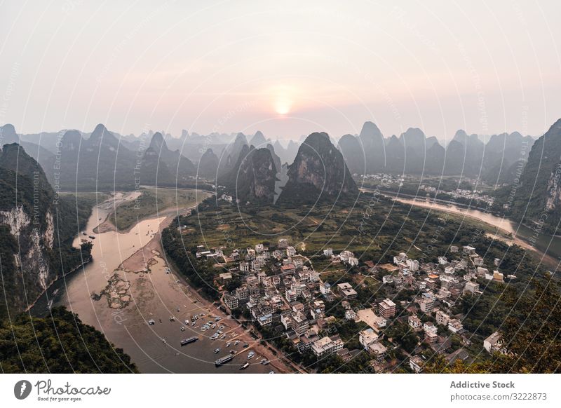 Coastal town surrounded with rocky mountains seaside coast travel bay remote drone view tourism architecture aerial green scenic small nature vacation beach