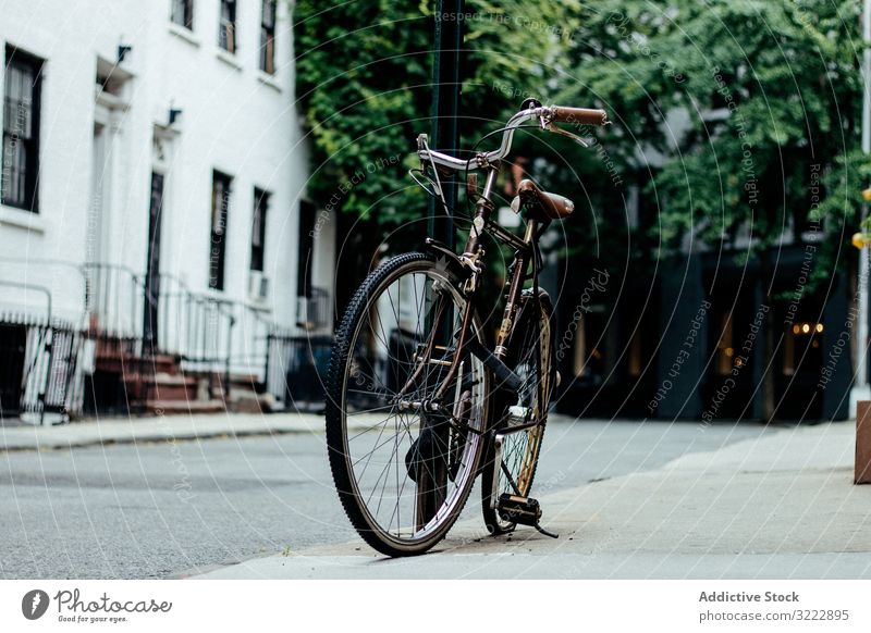 Bicycle parked on New York street bicycle sidewalk urban suburb pavement ride transportation lifestyle new york city tourism travel trip journey left nyc road