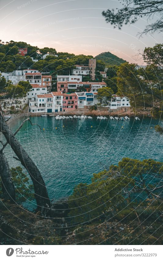 Sailboats on sea water against houses on rocky shore sailboat marina town bay twilight sunset travel tourism float moor harbor architecture summer yacht port