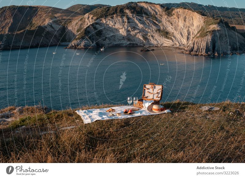 Picnic mat with romantically set near sea and mountains seaside picnic beach summer leisure sky relax glass drink vacation summertime vintage fashion refreshing