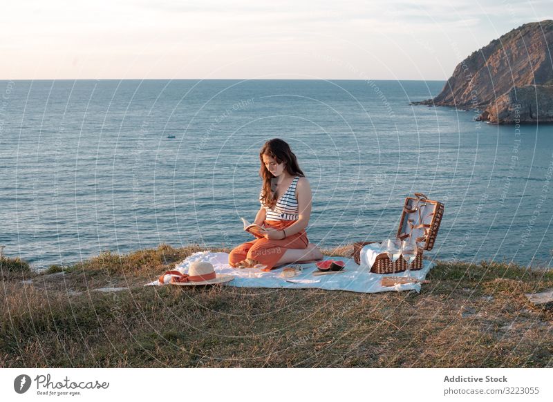 Woman reading on mat for picnic on seashore woman book seaside beach summer leisure sky relax glass drink vacation summertime vintage fashion refreshing