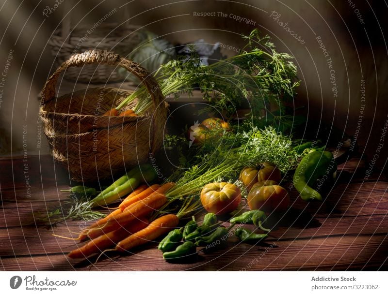 Vegetable still life in sunlight on wooden table vegetable tomato carrot green stem organic healthy fresh food nutrition vegetarian agriculture vegan farm