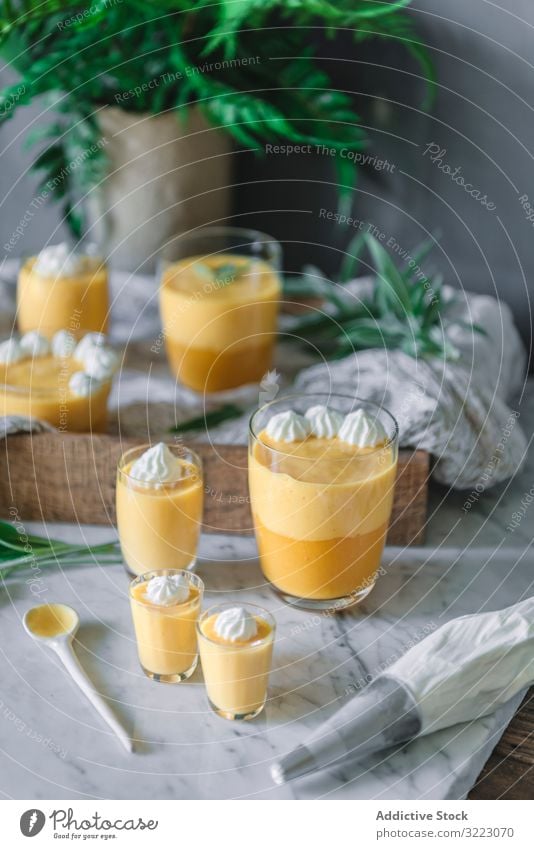 Mango dream in glass bowls on table mango cream mousse tasty food healthy dessert lunch yellow snack dish detox vegetarian decoration vegan delicious gourmet