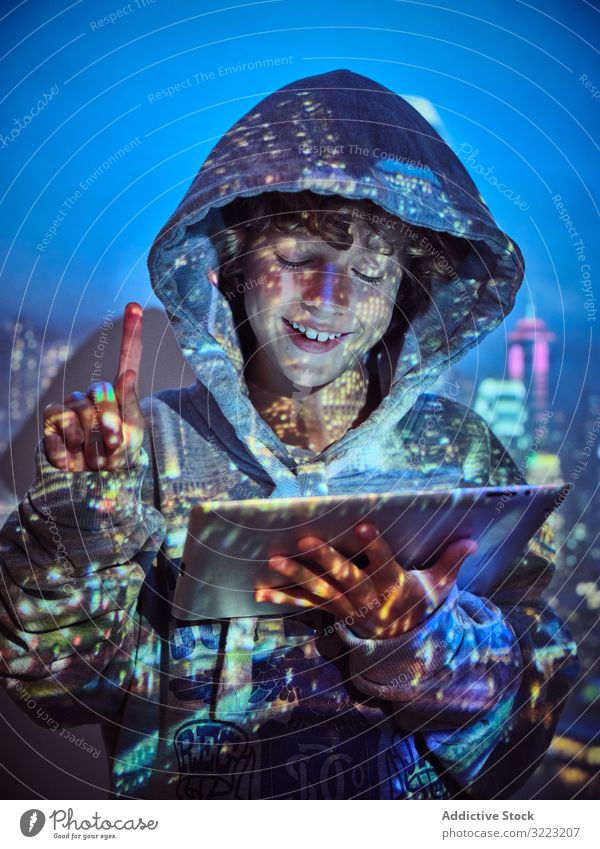 Hacker boy using tablet hacker code database little programmer virus digital password software kid child device gadget browsing hoodie scam website symbol glow